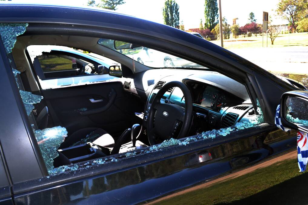 NOVEMBER: One of the vehicles parked on the Mitchell Highway which had its two front windows smashed. Photo: PHILL MURRAY 111913pglass1