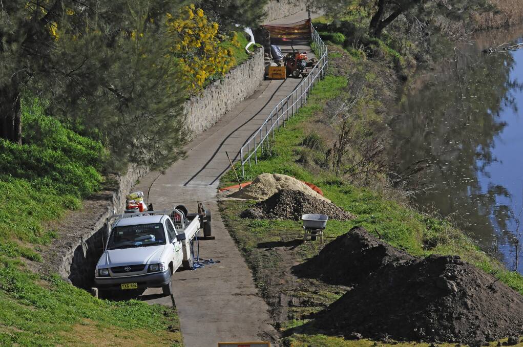 JULY: Repair work is being carried out on the stone wall that borders the walking path along the banks of the Macquarie River. Photo: PHILL MURRAY. 072513pwall1