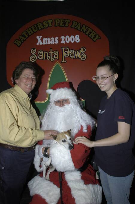 2008: RSPCA president Margaret Gaal, Santa Paws (aka Kent Fish) and Amber Hadson from Bathurst Pet Pantry. 121608cpaws1a