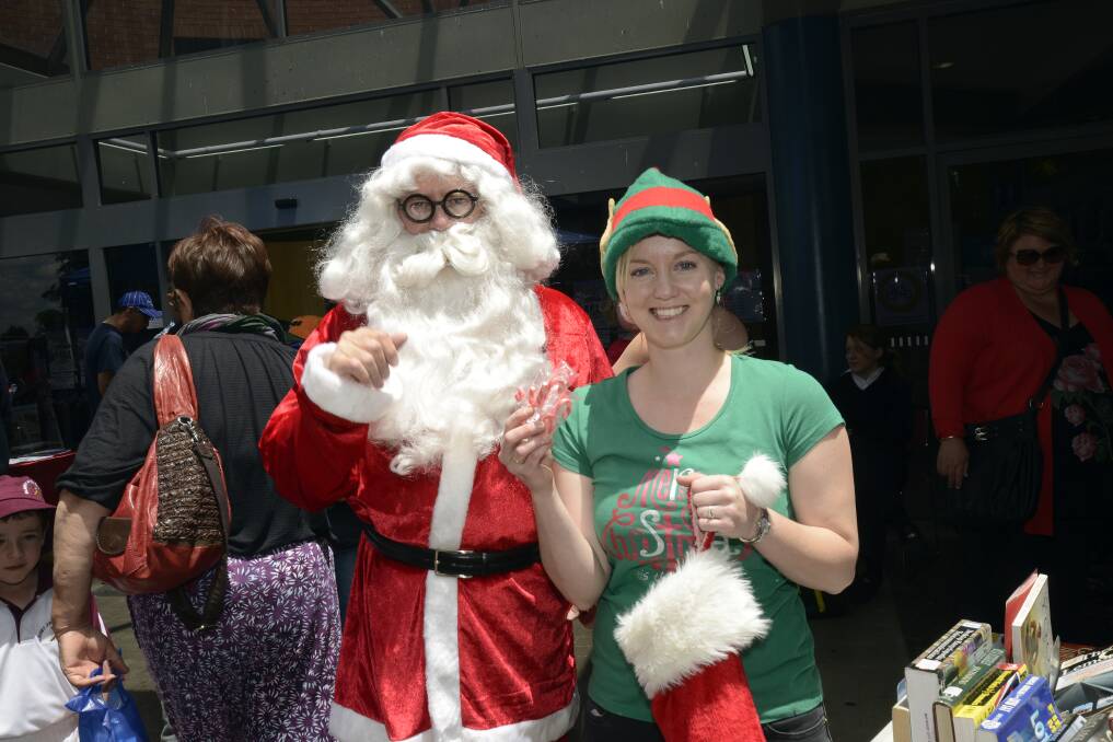 2013: Santa Claus with his elf helper Natalie Conn at Christmas in Keppel Street.