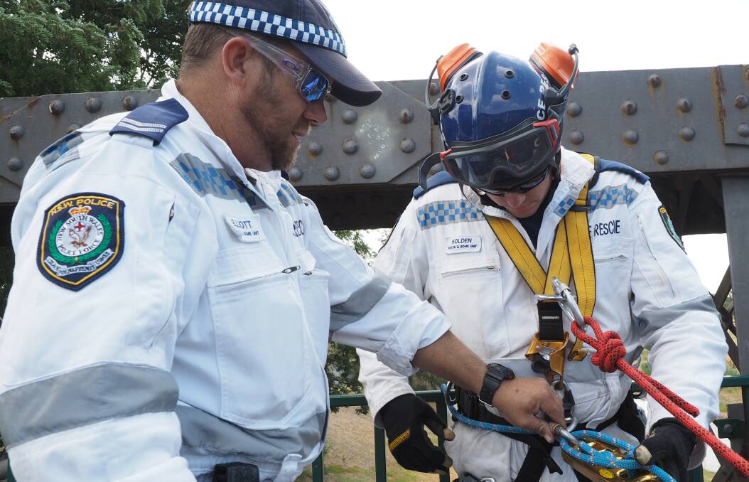 TRAINING: Constable Matt Holden, part of the Chifley police rescue team, abseiling off the old Denison Bridge as part of a training program beside the Macquarie River.