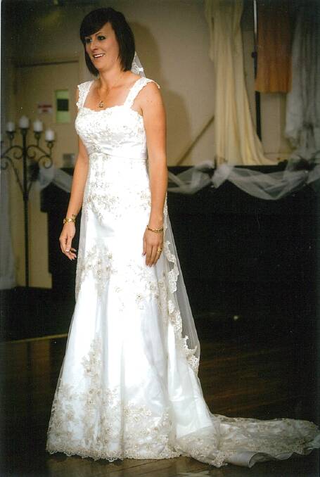 2003: Satin dress with an overlay of fine tulle trimmed with gold lace. The veil fell from the back of teh head and was trimmed with gold lace. Melissa Johnson wore this dress on her wedding day and also wore it on the night.