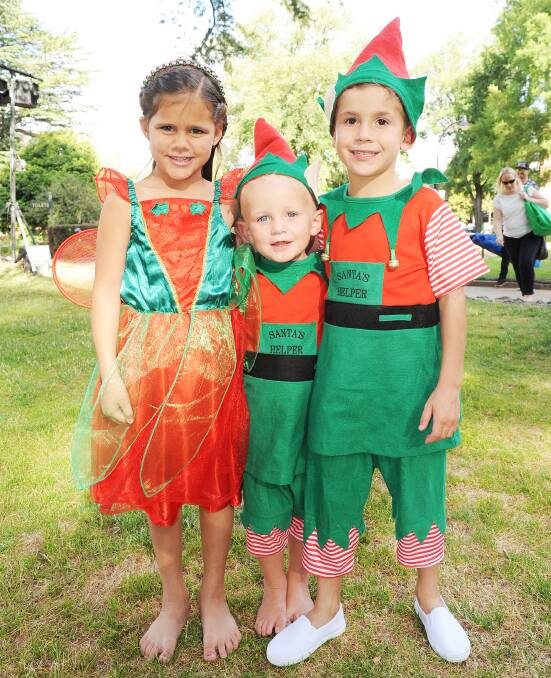 DECEMBER: Jasmine Mitchell, Cooper Belbin and Jackson Bellinger embraced the festive spirit at the Carols by Candlelight in Machattie Park last night. Photo: CLARE LEWIS. 121513mac