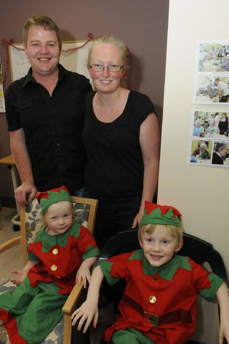 SNAPPED: Andrew and Suzy McLeod with elves, Liam and Lily at St Vincent's Christmas party. 121213pvinnies2  