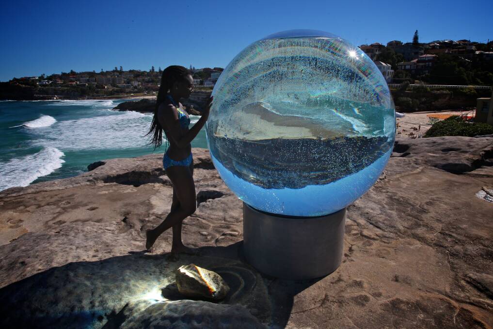 SCULPTURE BY THE SEA: Awa Diagne from South Coogee looking at Lucy Humphrey's sculpture. Photo: Danielle Smith