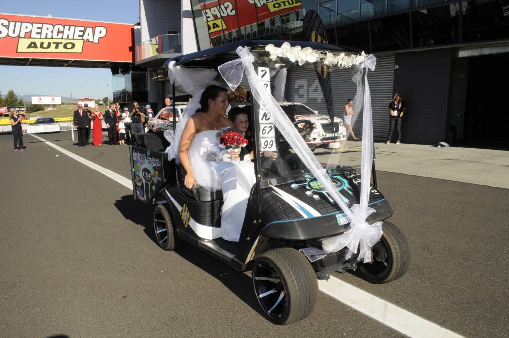 2013: India and Shane Clarke pose for photos following their wedding at Mount Panorama on October 9. The wedding ceremony was performed by Reverend Stephen Peach in Pit Lane. The Griffith couple married in the presence of other race fans, volunteers, drivers and the media.