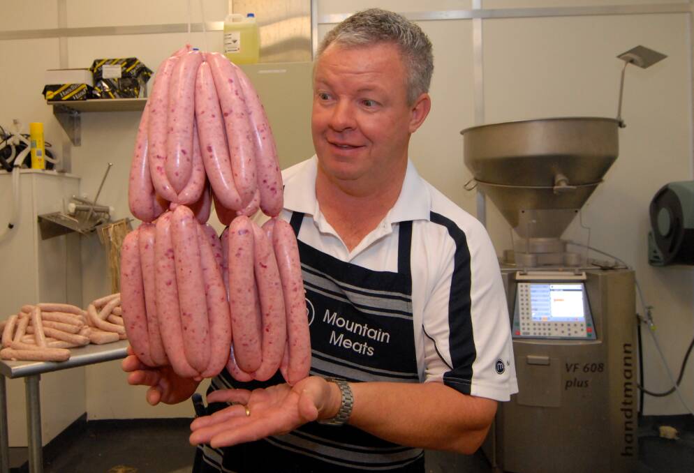FEBRUARY: Paul Smith, of Mountain Meats, with his pink sausages he sold to raise funds for the McGrath Foundation. Photo: ZENIO LAPKA 022113zsausage