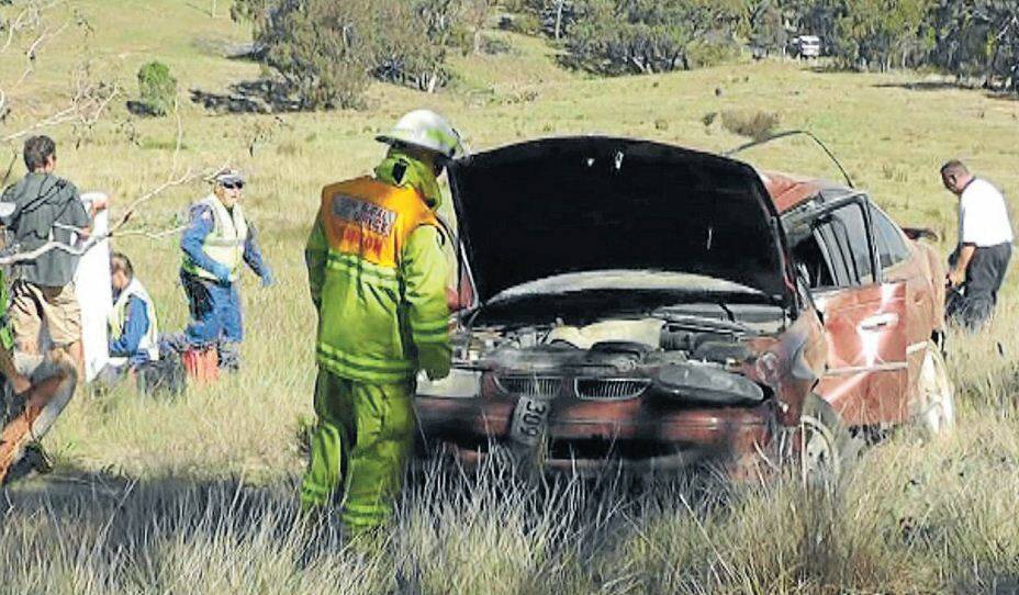 MARCH: Rescue workers at the Turondale crash site where a 12-year-old boy managed to crawl from the wreckage and raise the alarm. Photo: ANDREW MICALLEF, WIDE AREA COMMUNICATIONS 032513crash2