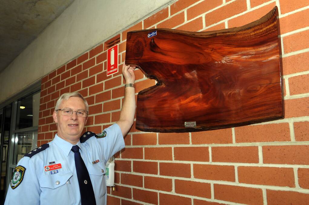 SEPTEMBER: Chifley local area command Inspector Colin Cracknell with the new honour board now taking pride of place in Bathurst police station. Photo: PHILL MURRAY 091213pcol