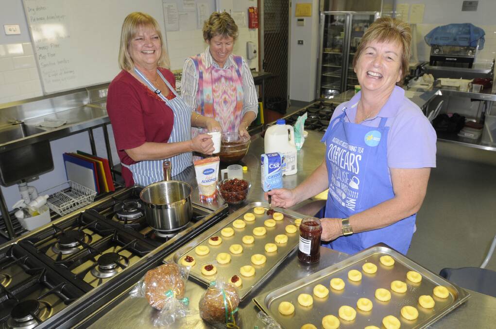 MAY: Donna Bosson, Liz Johnson and Jenny Moore prepare treats for an Australia's Biggest Morning Tea fundraiser to be held in Kelso.