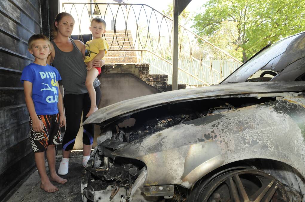 NOVEMBER: Krystal Towers and her sons Blaize, 9, and Kye, 4, were asleep in their South Bathurst home when arsonists set fire to their car. Photo: PHILL MURRAY 110113pfire1
