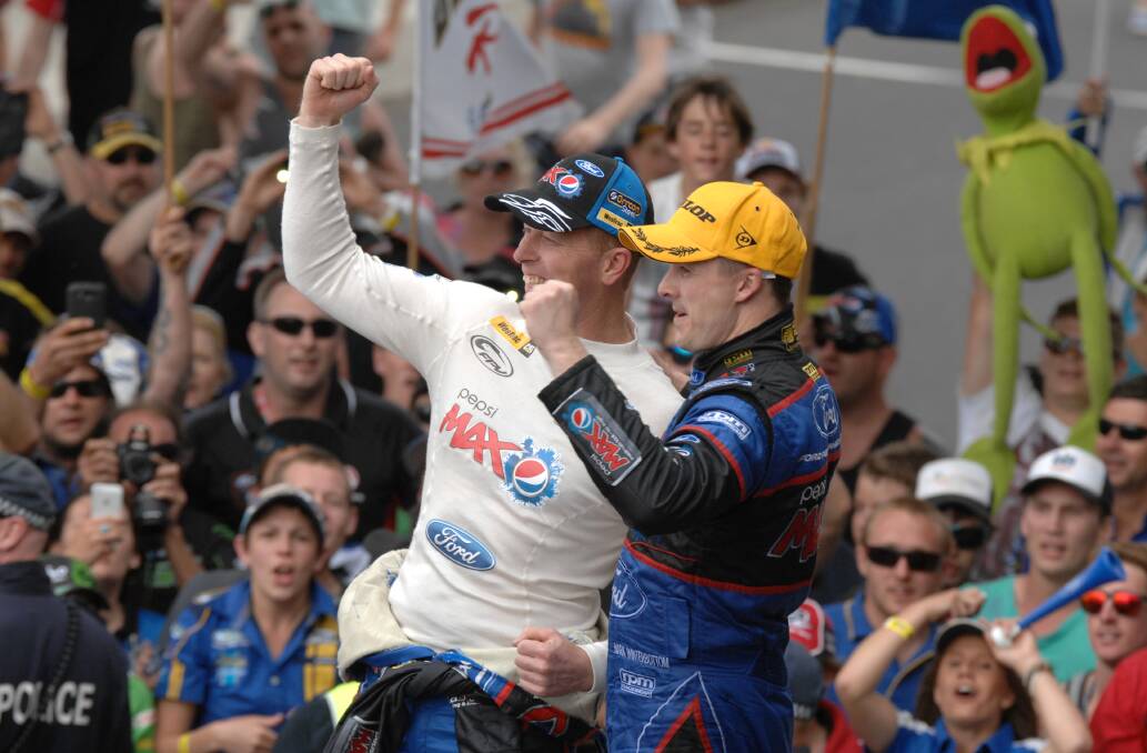 OCTOBER: Mark Winterbottom (right) and co-driver Steven Richards greet the Ford faithful following their Bathurst 1000 victory. Photo: ZENIO LAPKA 101313zfrosty