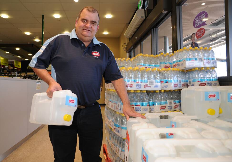 JULY: Bernardi’s Marketplace Supa IGA manager Geoff Bottom got in pallets of water following a failure at the city’s water filtration plant. Photo: ZENIO LAPKA 063013ziga