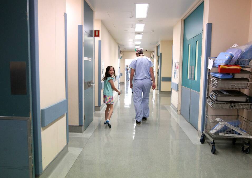 BRAVE BROOKE: Brooke MacKenzie walks towards the operating theatre prior to her brain operation at Westmead Children's Hospital in Sydney. Photo: Janie Barrett