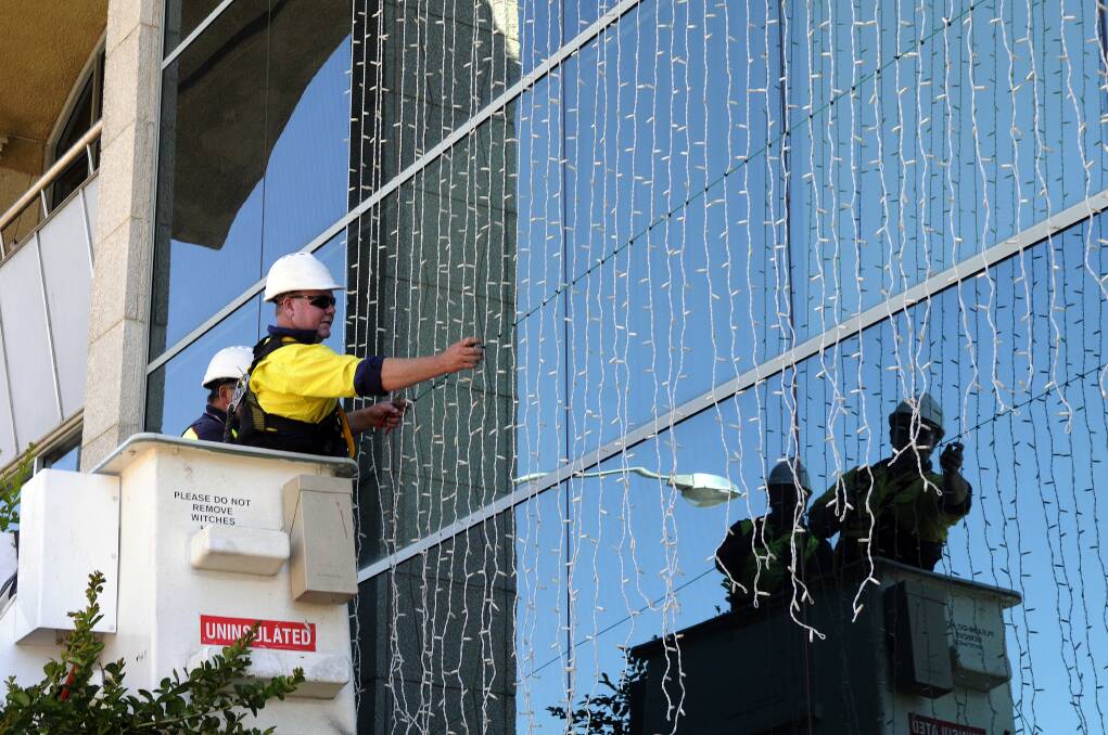 DECEMBER: Staff from Bathurst Regional Council put up the Christmas lights at the civic centre in Russell Street.