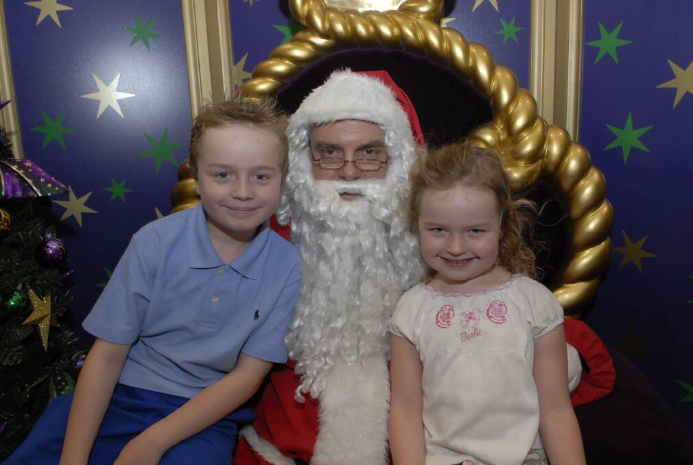 2010: Santa with Travis, 7, and Victoria Barrie, 4.