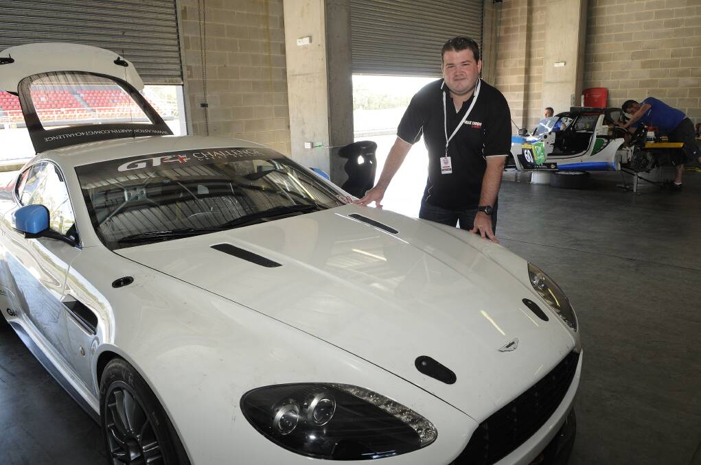 BOOMING: Bathurst 12 Hour media manager Richard Craill with the Aston Martin Vantage, one of the first-time entries in this year's race. Photo: PHILL MURRAY.	 020613pric