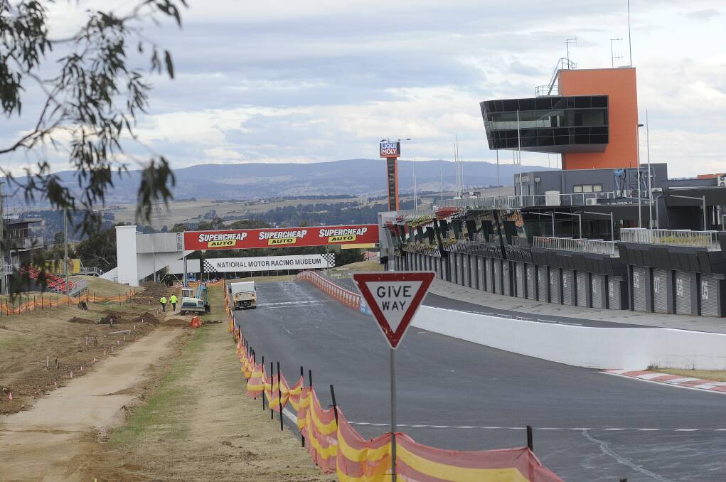 NEW LOOK: Motorsport fans would hardly recognise Pit Straight at Mount Panorama as it undergoes a massive transformation. The outer Armco barrier has gone, making way for a wider track, concrete wall and debris fencing. Photo: CHRIS SEABROOK  052113cmtp3