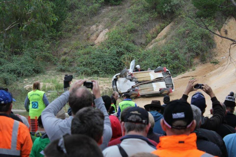 RALLY OVER: The Subaru of Bathurst driver Leigh Gotch lies on its side after crashing in the National Capital Rally on Saturday.