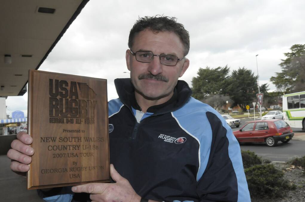 EVOLUTION: Dave Conyers shows off the plaque commemorating the 2007 tour of the United States which his NSW Country under 18s side conducted. The former Bathurst resident is now coaching in the US. 	070809pdave