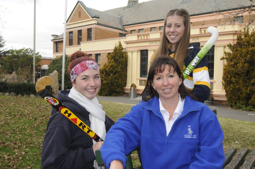 BIG TASK: From left, McKenzee Newton, Jacqui Hood (coach) and Emma Siejka have a tough assignment tomorrow as they take on Orange High in girls hockey as part of the Astley Cup competition. Photo: CHRIS SEABROOK 	061713cbhs