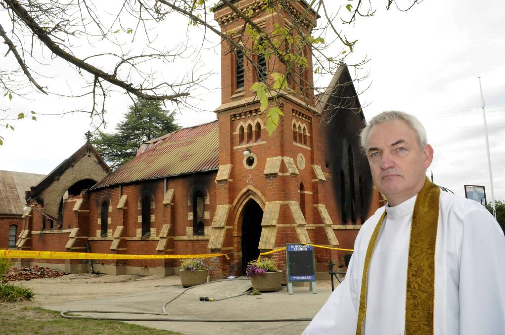 DEVASTATED: Father James Hodson outside St Barnabas’ Anglican Church yesterday. Photo: CHRIS SEABROOK  022314church2