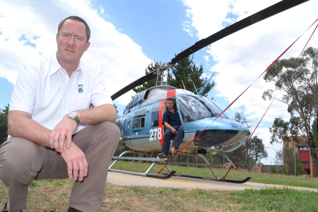 READY FOR ACTION: Forests NSW regional manager Gavin Jeffries and helicopter pilot Sean Doherty were on fire alert yesterday, ready to respond to any blazes across the region. Photo: BRIAN WOOD	 010813chopper1