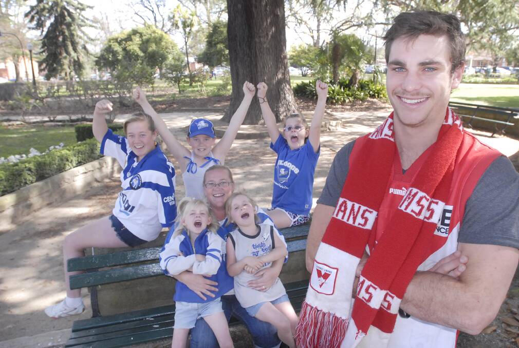 FINALS FEVER: Swans supporter Ryan Noakes (front) and keen Bulldogs fan Liz Arrow with her daughters Hannah, 4, Tarli, 6, Felicity, 13, Chloe, 11 and Tiffany, 10. Photo: CHRIS SEABROOK 092612cfans