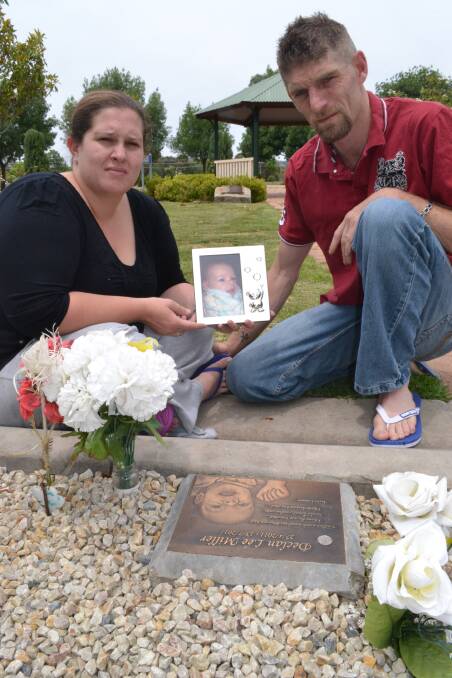 DISGUSTED: Local couple Samantha and Paul Miller at the Birralee baby section of the Bathurst Cemetery where their son Declan is buried.	120712baby2
