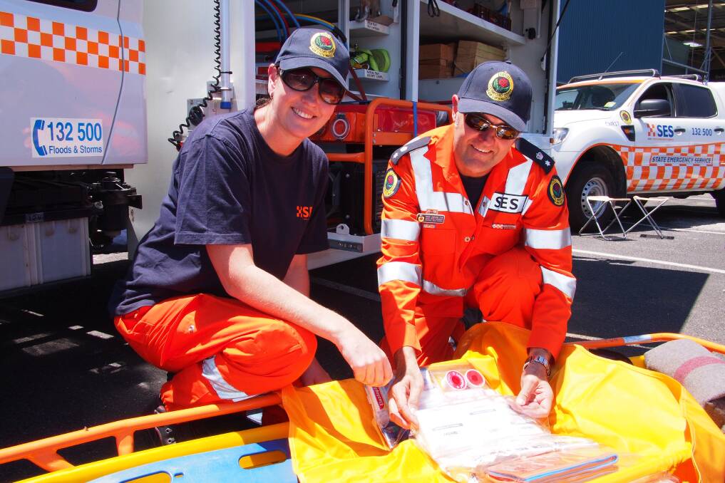 NUMBERS GAME: SES volunteers Sharon Bowrey and deputy regional controller Mark Darling at the SES recruitment drive at Bunnings on Sunday. Photo: ZENIO LAPKA 010514zses