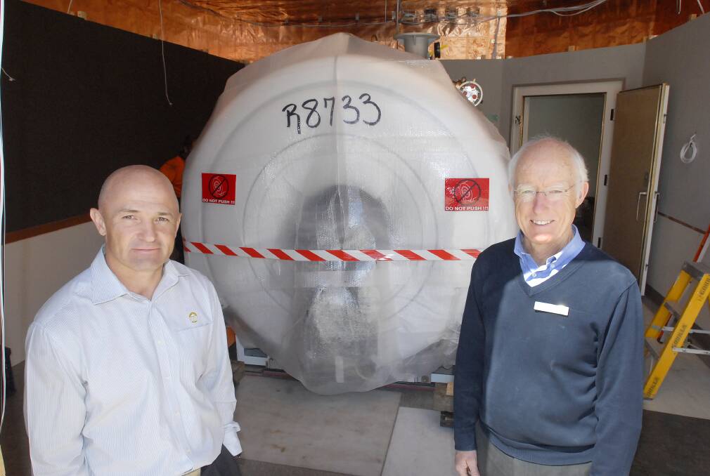 NO MORE TRAVEL: Chief radiographer David Adams and radiologist Dr Michael Jones with Bathurst’s first MRI scanner. Photo: CHRIS SEABROOK 	091712cmri1