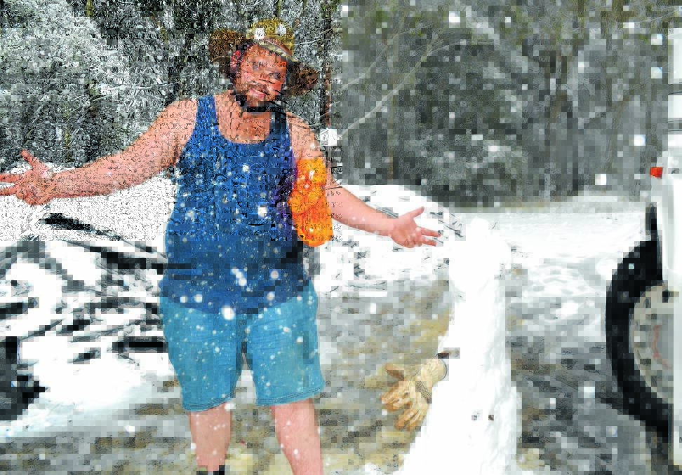 BIG DUMP: Goulburn truckie Daniel Strangers pulled off beside the Great Western Highway at Yetholme yesterday because of the heavy snow and made the most of the conditions by making a snowman. Photo: BRIAN WOOD 101212snow