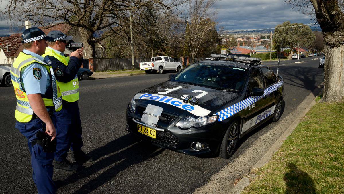 BATHURST: SLOW DOWN: Senior Constable Ian Stibbard and Constable Mick Ridings conducting speed checks in the school zone outside Bathurst High School on Keppel Street. Photo: PHILL MURRAY 082213pspeed1
