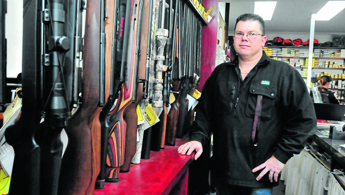 ORANGE: Bullets and Bits owner Ray Hawkins welcomed the idea of a Smartcard system to record details of purchases. Photo: JUDE KEOGH 0726guns