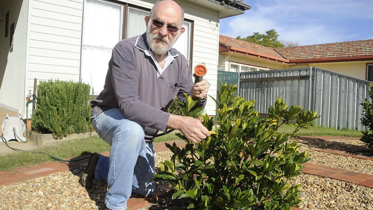 DUBBO: Pensioner Ken Windsor watering his garden, which is set to cost him an extra $80 in the financial year beginning July 1, unless Dubbo City Council changes its policy.  Photo: Cheryl Burke