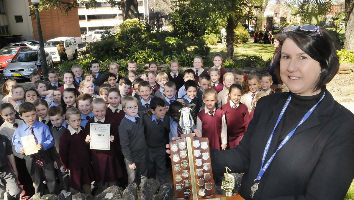 BATHURST: Music teacher Rosemary Fogarty with the Holy Family School choir that placed first in the Years 1-2 section on day one of the Bathurst Eisteddfod. Photo: CHRIS SEABROOK 082713cefod