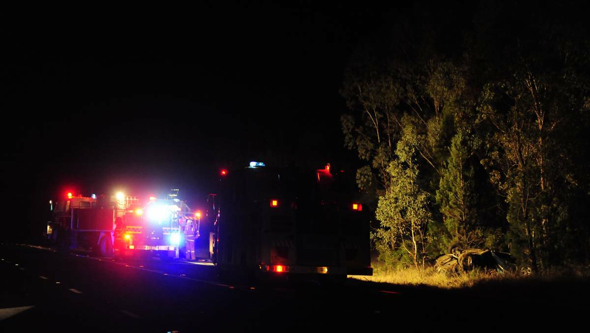 DUBBO: Emergency services and fire crew attend the scene of the accident 24 km south of Dubbo on Monday evening.  The woman at wheel of the car that crashed and killed a child passenger, was a disqualified driver. Photo: Belinda Soole. 