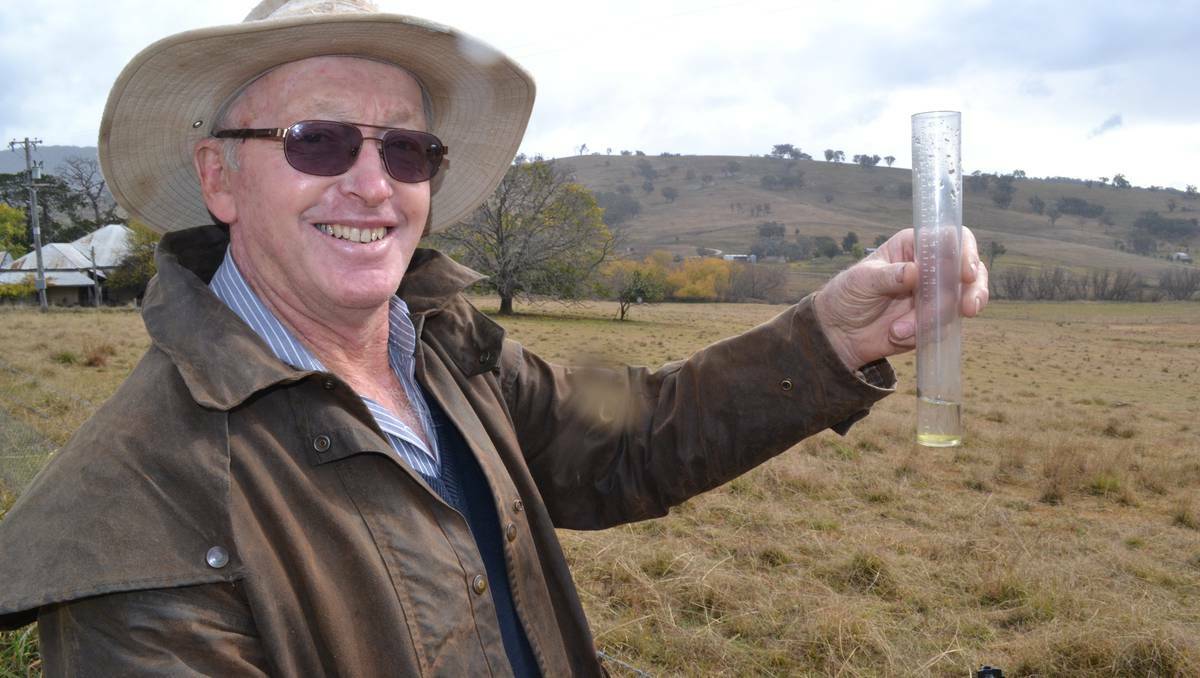 BATHURST: Brian Seaman was all smiles as he checked the rain gauge yesterday at his 1400-acre property ‘Huntleigh’ at The Rocks. Despite falls this week, Mr Seaman knows it’s going to be a long, tough winter ahead. Photo: BRIAN WOOD