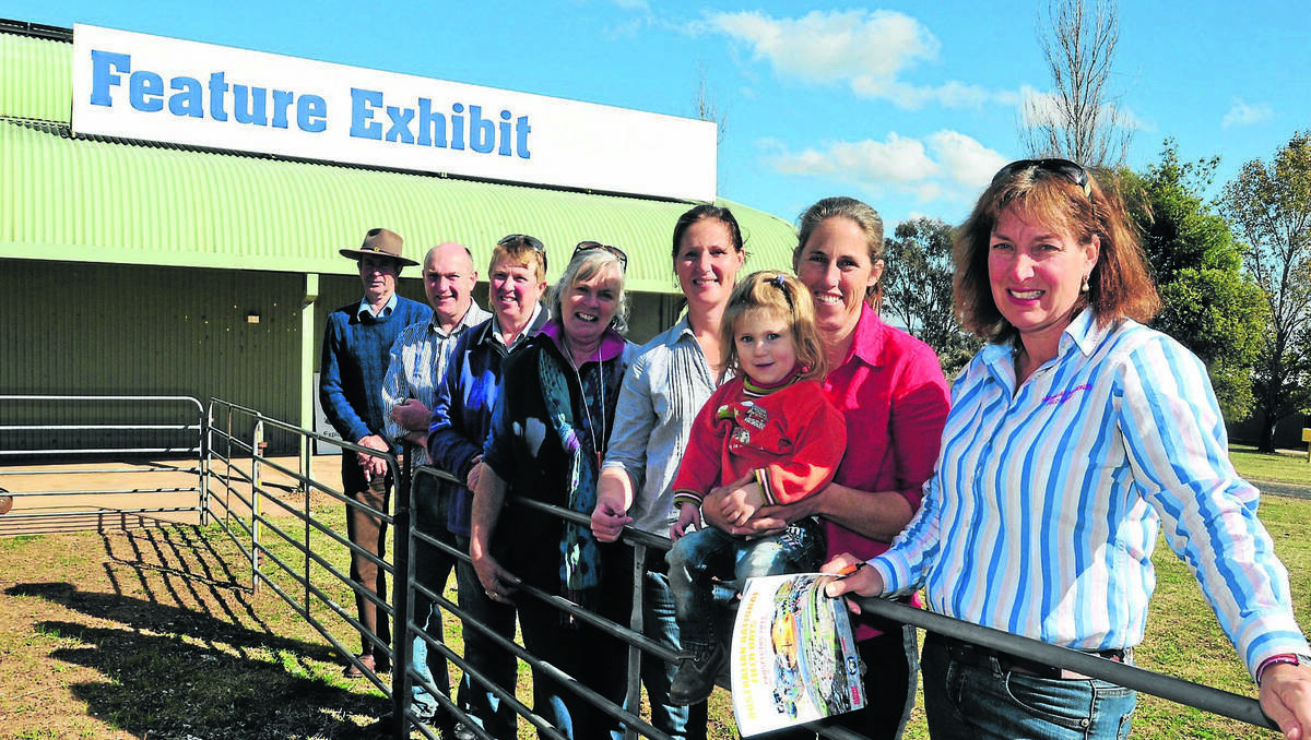 ORANGE: Ken Williams, Scott Munro, Ann Fragar, Jenny Gilbertson, Isabele Roberts, Ruth Klingner (and daughter Naomi) and Jayne West can’t wait to inform visitors to the Australian National Field Days about lamb. Photo: JUDE KEOGH 0801fielddays1
