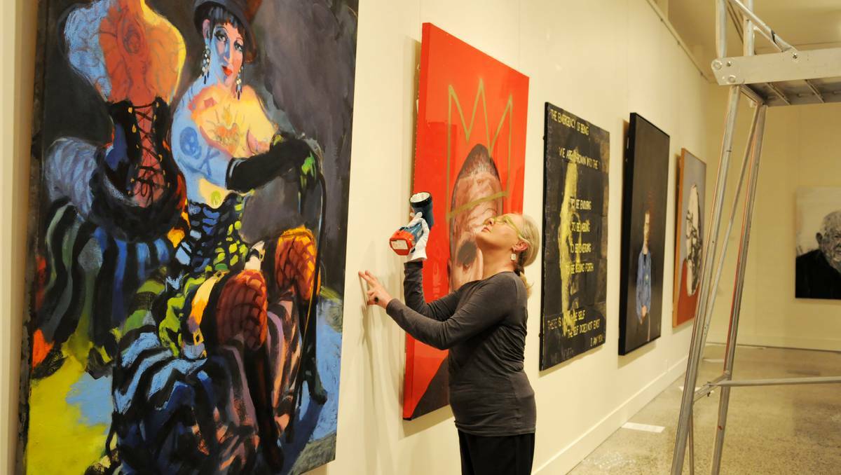 Bathurst Regional Art Gallery acting curator Robina Booth checks a work by Wendy Sharpe (Venus Vamps Burlesque Star) ahead of tonight’s Archibald Prize exhibition opening. Photo: ZENIO LAPKA	 082913zart1