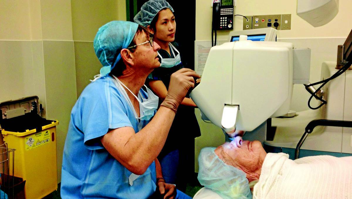 ORANGE: Dr Basil Crayford and nurse Narelle Alexander during a laser procedure on the eye to correct a cataract. 0516laser1