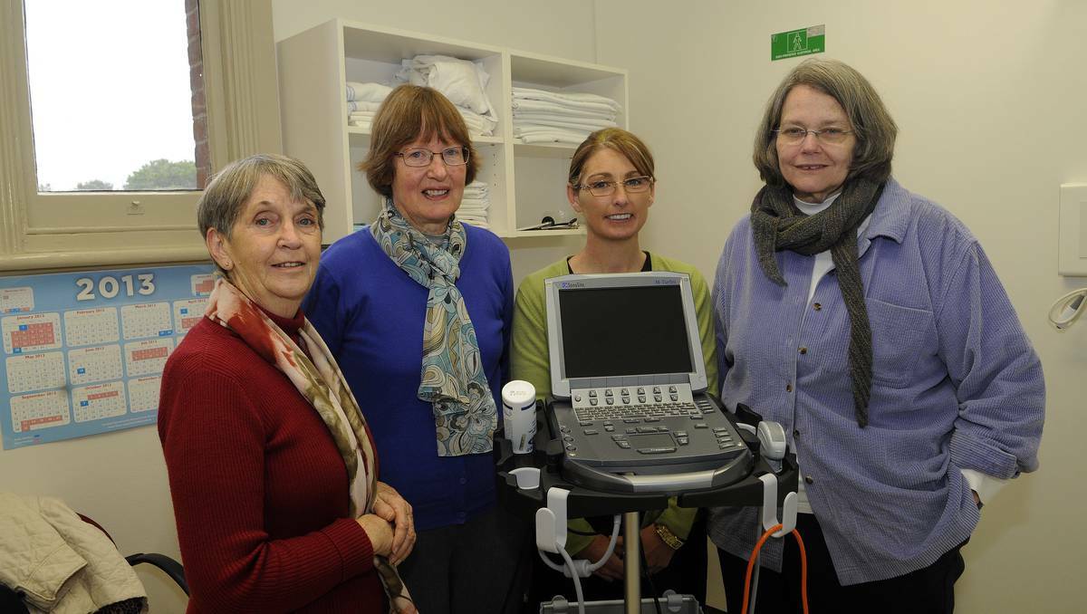 BATHURST: Auxiliary members Nancy Pickup and Jill Mitchell hand over the new ultrasound machine to community allied health manager Jackie Corliss and Dr Christine Smith from Bathurst hospital. Photo: PHILL MURRAY	061213paux