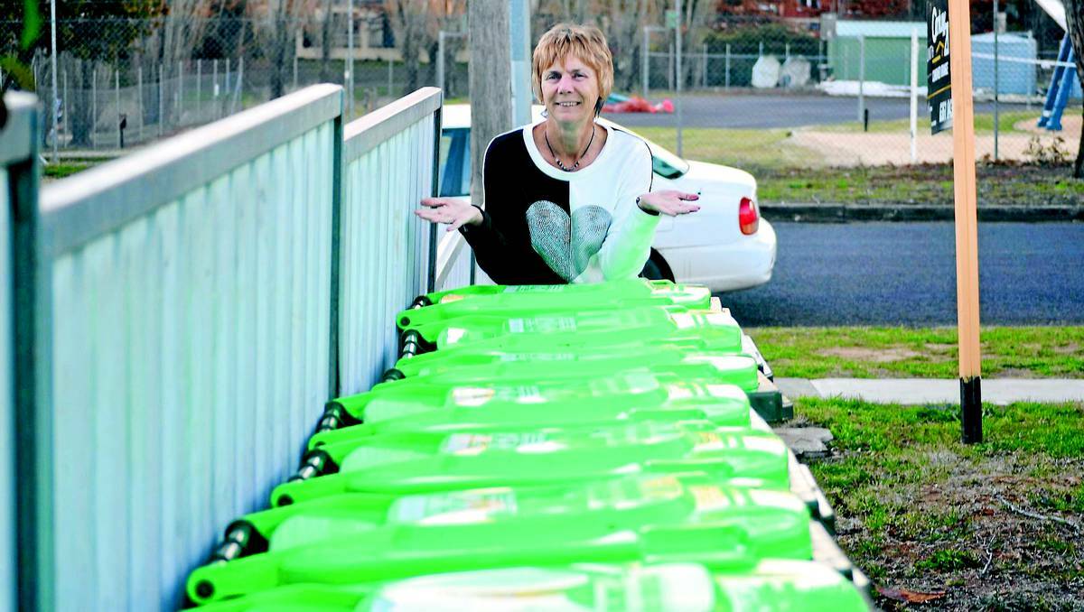 ORANGE:  Vicki Garrood can’t work out how her mother’s 16 unit block in Warrendine Street has six red bins, six yellow bins but 16 green bins, all of which, when on the street make it impossible to drive through. Photo: NICOLE KUTER 0703nkbin