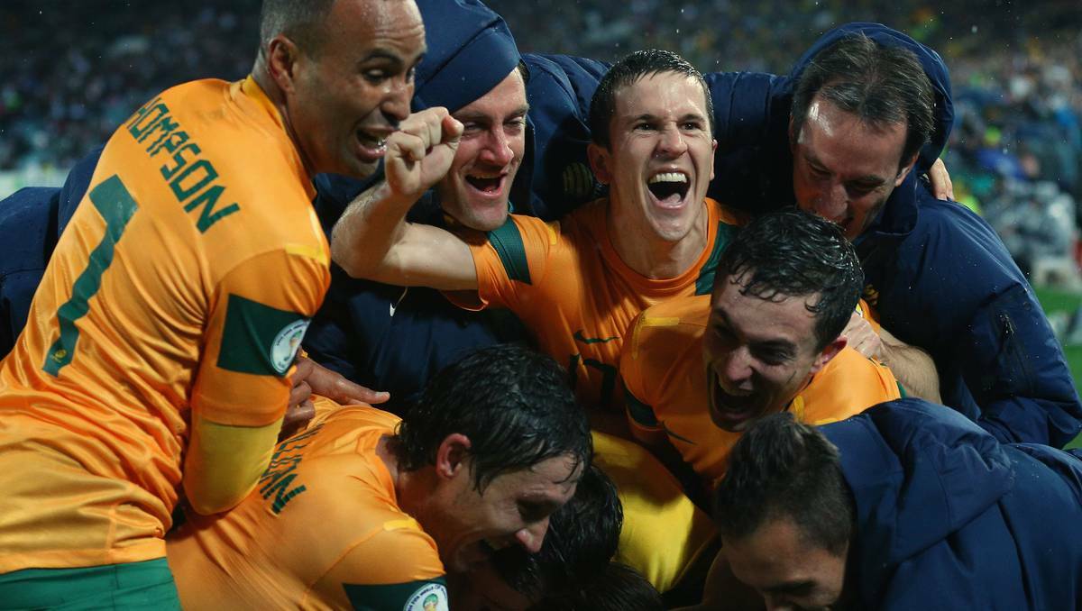 Bathurst soccer product Archie Thompson (left) and his Australia team-mates celebrate the 1-0 win over Iraq on Tuesday night that saw them gain automatic qualification for the 2014 World Cup. Photo: GETTY IMAGES 061813arch