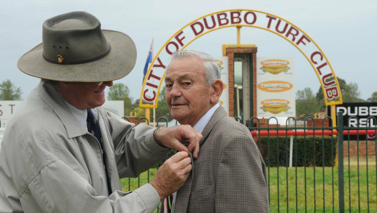 DUBBO:Dubbo Turf Club chairman, Rebert Ellis, presents Col Hepper with his new patron's badge. Photo: LOUISE DONGES