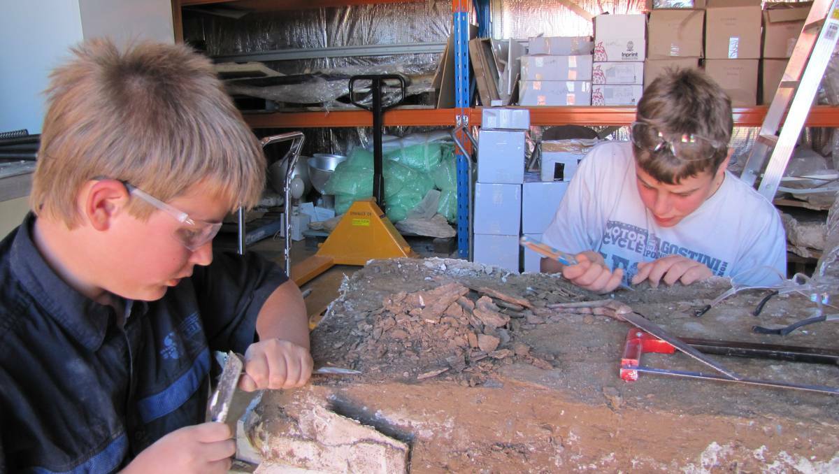  Bathurst locals James and Sam Gordon work on the Ichthyosaur fossil they found in Queensland. 051513fossil