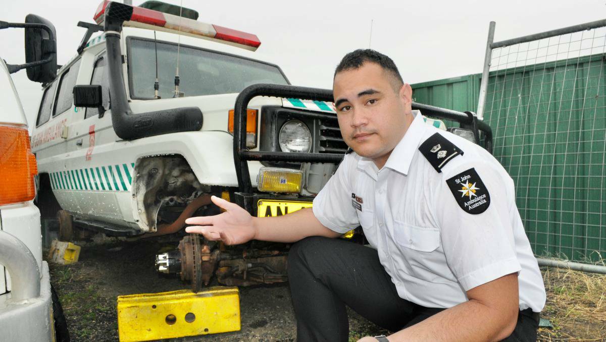 BATHURST: St John Ambulance superintendent Joshua Clark with the four-wheel drive that was robbed of its four tyres.