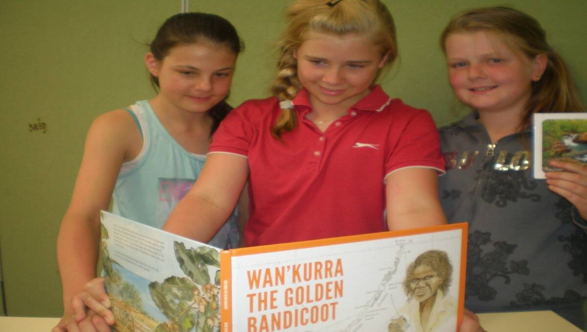 Students Hannah Dopper, Georgia Shiels and Mig Robinson read through Wan’kurra the Golden Bandicoot. PHOTO: Eglinton Public School