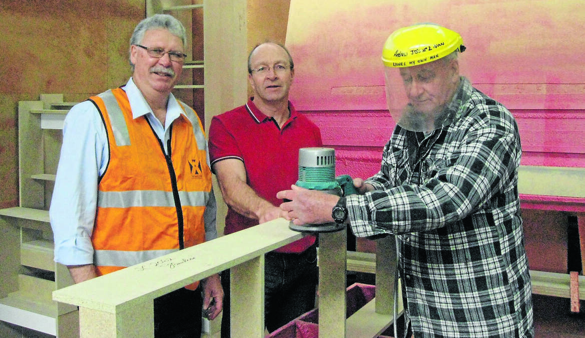 ORANGE: Orange and District WorkCover co-ordinator David Young with JD Kitchens sales and design manager John Connolly and worker Lionel McKenzie, who is demonstrating the safe use of hand tools after concerns at a growing number of hand injuries in the industry. Photo contributed