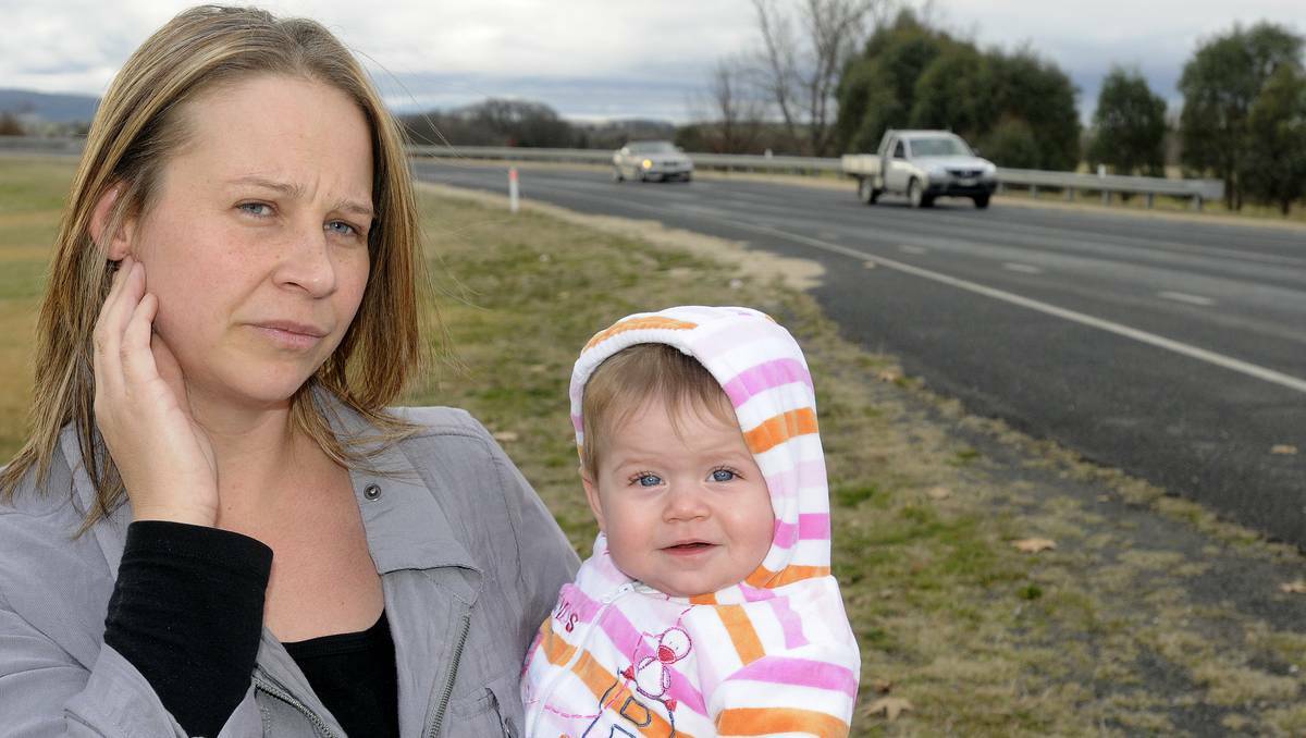 BATHURST: Kelly Sargent-Bright with her eight-month-old daughter, Hallee, near the spot on Eglinton Road where her ute was egged by a passing motorist. Photo: CHRIS SEABROOK	 061713cegged